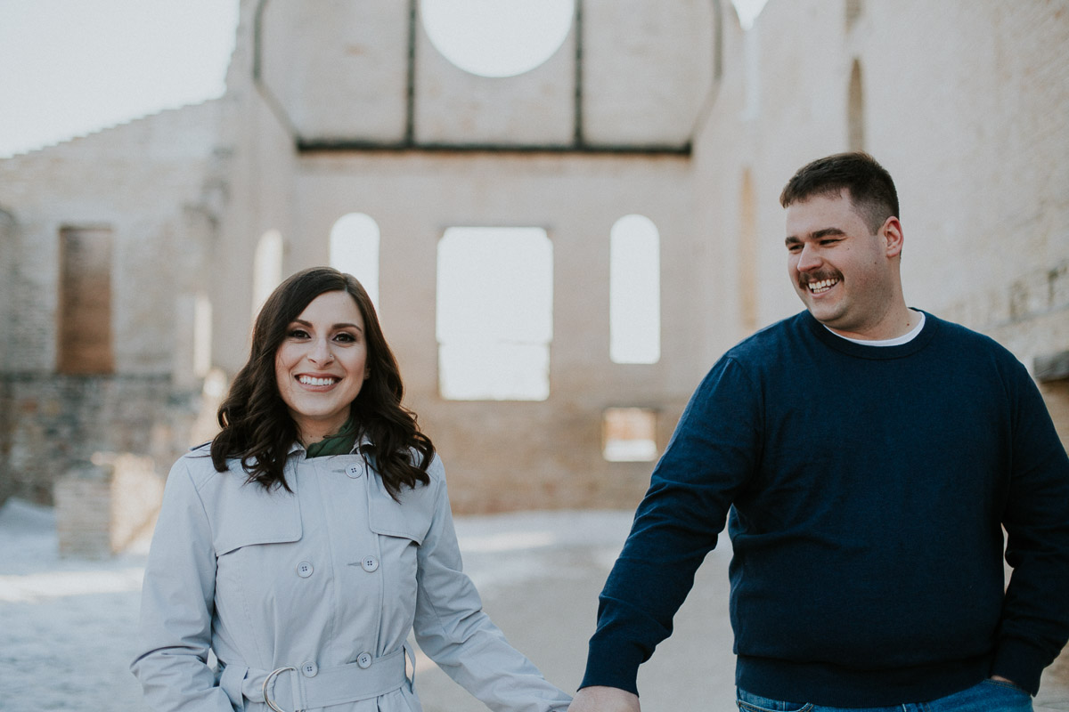 Winnipeg couple walking and laughing at engagement session